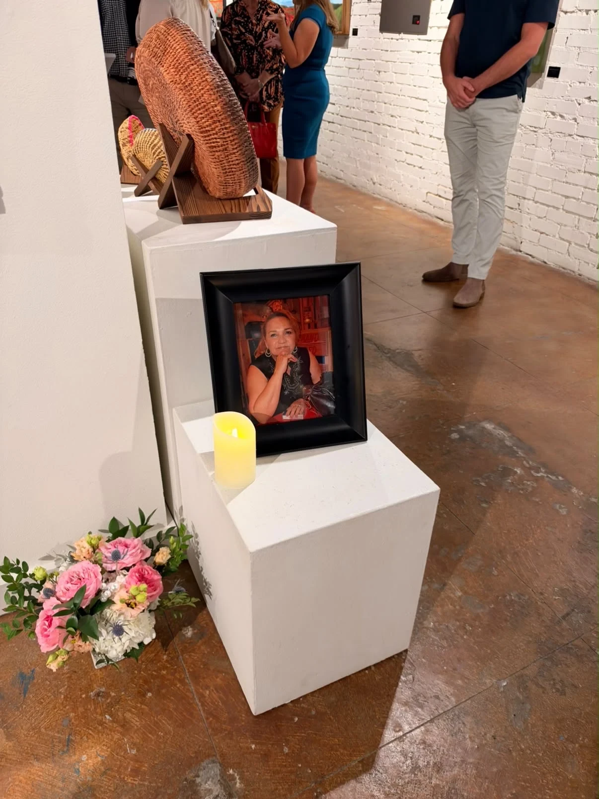 A framed photograph, candle and flowers beside the tribute display.